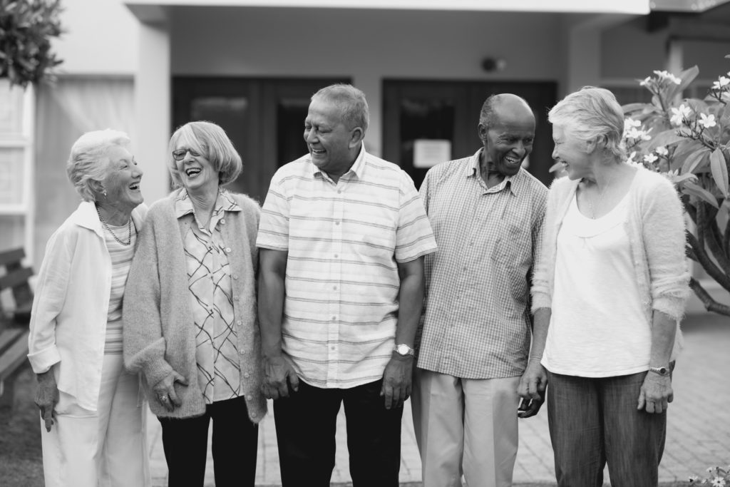 Cheerful senior men and women at nursing home